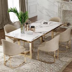 a marble dining table surrounded by beige chairs and a plant in a vase on top