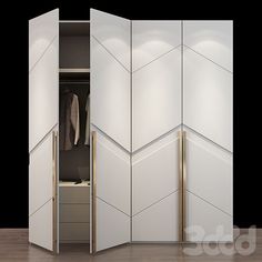 an open closet with white walls and gold trimmings on the doors, in front of a wooden floor