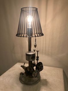 a lamp that is sitting on top of a table next to a light bulb in the shape of an engine