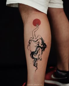 a tattoo on the leg of a person with a red sun behind her and a woman holding a flower