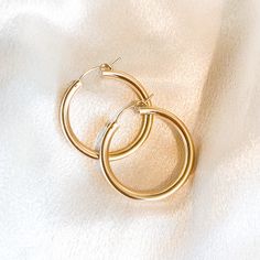 27mm x 3mm thick style gold filled hoops that are perfect for everyday wear. These measure a little over 1 inch across. You never have to take these off. Made to last and made to live in. 100x more gold than plated jewelry. Gold filled is waterproof, tarnish proof and great for sensitive ears. Hawaii x California. Everyday 14k Gold Filled Huggie Earrings, Classic Small Hoop Earrings In 14k Gold Filled, Nickel-free Yellow Gold Huggie Earrings For Everyday, Everyday Nickel-free Huggie Hoop Earrings, Simple Small Hoop Everyday Jewelry, Simple Gold Huggie Earrings Tarnish Resistant, Tarnish Resistant Hoop Earrings, Everyday Tarnish Resistant Hoop Earrings, Everyday Small Hoop Earrings Tarnish Resistant