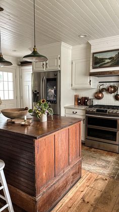 a kitchen with wooden floors and white walls