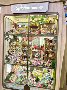 a display case filled with lots of toys and figurines in it's windows