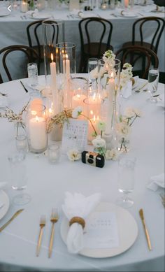 the table is set with candles and place settings