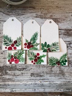 four tags with holly and berries on them