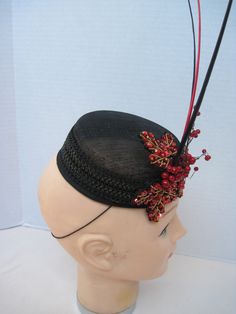 "* Designed on a black Sinamay pillbox hat form this hatinator will take you anywhere you want to go and will catch many eyes. The design includes a wide black leather braided trim complemented by handmade red sequen and bead worked Maple Leaves. To add a touch more of detail shiny red berries look good enough to eat. * The three black and red quills give dramatic height to the piece and upon ordering this is the exact fascinator you will receive. * With a hat diameter of 5.5\" it qualifies as f Black High Crown Hat For Evening, Black High Crown Hat For Formal Occasions, Black High Crown Costume Hat For Formal Occasions, Formal Black High Crown Costume Hat, Formal Black Mini Hat With High Crown, Formal Black High Crown Mini Hat, Vintage Black Fascinator For Party, Black Top Hat With Structured Crown For Party, Black Top Hat With Short Brim For Party