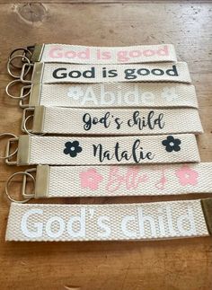 four key fobs with the words god is good and god's little nature on them