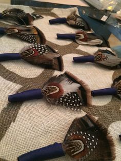 there are many birds on the table with blue handled brushes in it's beaks