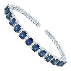 This stunning and exemplary bangle bracelet is crafted in 18K white gold. Starring prong set radiant rich blue emerald cut sapphires weighing 10.20 carats and baguette cut diamonds weighing 1.20 carats. Length: 7.25 inches. Width: 3.7mm. Total weight: 23.80 grams. Comes with a presentable gift box. Antique Bangles, Diamond Bangle Bracelet, Diamond Jewelry Set, Blue Sapphire Necklace, Blue Emerald, Yellow Gold Bangle, Antique Bracelets, Diamond Bangles Bracelet, American Modern