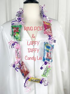 a white mannequin with candy and candies on it's neck, along with the words ring pop & laffy taffy candy lei