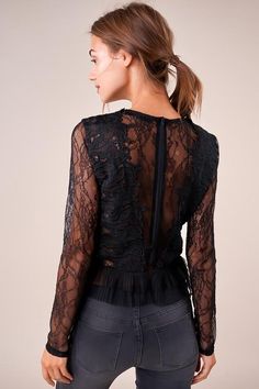 The Temptress is a sheer lace top covered in a floral design. The top features a high neckline, long fitted sleeves, and a darted bodice with a cropped, pleated hem. This ultra-sultry number is perfect for showing off your midriff in jeans and heels. Model is 5'9" and wearing size small. Pre-Order Now! Estimated Shipping Date October 25, 2019. Available in black. 100% polyester. Imported. Fitted Lace Mesh Top With Lace Trim, Lace Mesh Top With Lace Trim For Night Out, Fitted Long Sleeve Lace Top, Sheer Sleeves Lace Top For Night Out, Sheer Lace Top For Parties, Sheer Lace Top For Party, Chic Tops With Lace Bodice For Night Out, Lace Cropped Top For Night Out, Chic Lace Bodice Top For Night Out