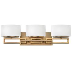 three light bathroom fixture with white shades on the top and bottom lights in polished brass finish