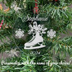 a personalized ornament hanging from a christmas tree with snowflakes on it