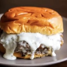 a meatball sandwich with cheese and sauce on a plate