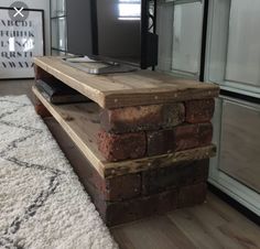 a flat screen tv sitting on top of a wooden stand