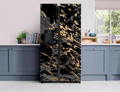 a black and gold refrigerator freezer sitting in a kitchen next to a counter top