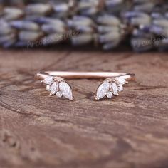 a close up of two rings on top of a wooden table