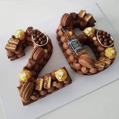 a cake made to look like the number 50 with chocolates and nuts on it