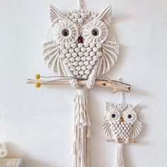 an owl is hanging on the wall next to two owls