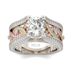 a white and yellow gold ring with an intricate design on the side, surrounded by diamonds