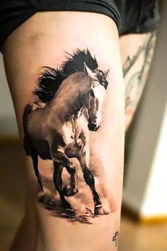 a woman's leg with a horse tattoo on the side of her leg and an image of a horse running behind it