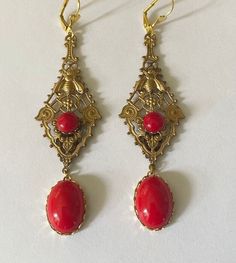 "Very dramatic pair of  Art Deco statement earrings in Ornate Bohemian  style  Lovely Antique gold Filigree panel set with red glass stones and bee motif   Finished with vintage red glass stones cabochon drops to the bottom Earrings look very dramatic on & will generate lots of comments  Earrings have lever back wires gold plated  for pierced ears, lead & nickel free In excellent condition Size: just over 3 & 1/2\" (9 cm) long ,  these are quite long so please check size before buying- if big ea Ornate Red Earrings For Party, Ornate Red Dangle Earrings, Ornate Red Cabochon Jewelry, Formal Red Brass Earrings, Vintage Red Dangle Chandelier Earrings, Red Vintage Dangle Chandelier Earrings, Red Vintage Chandelier Dangle Earrings, Vintage Red Drop Clip-on Earrings, Red Vintage Style Drop Clip-on Earrings