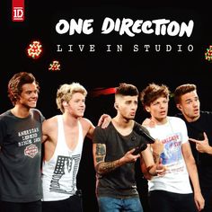 the one direction band is standing together in front of a microphone and pointing at something