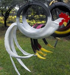 some kind of sculpture in the grass with chickens and roosters on it's sides