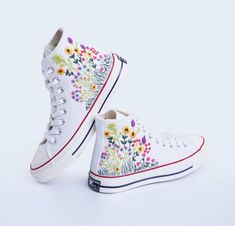 " CONVERSE CHUCK TAYLOR 1970 SHOES WITH CUSTOM FLOWER FIELD EMBROIDERY. WEDDING SHOES FOR BRIDE AND BRIDESMAIDS " Custom Embroidery Converse Sneakers/Bridal  Flower Embroidery shoes /Converse Sneakers Embroidered With Flower Gardens/Converse High Tops "Experience the art of hand embroidery on Converse embroidered shoes, a testament to meticulous craftsmanship."  💸 Price includes Converse Shoes and floral embroidery as shown 🌸 You can send me your Converse/Vans shoes or I can buy them for you. Spring Wedding High-top Sneakers, Multicolor Embroidery Sneakers For Spring With Round Toe, Multicolor Embroidered Spring Sneakers With Round Toe, Spring Multicolor Embroidered Sneakers With Round Toe, White High-top Sneakers With Floral Embroidery, 1970 Shoes, Field Embroidery, Embroidery Converse, Converse Chuck 70s