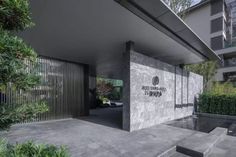 the entrance to an apartment building with stairs leading up to it and trees in front