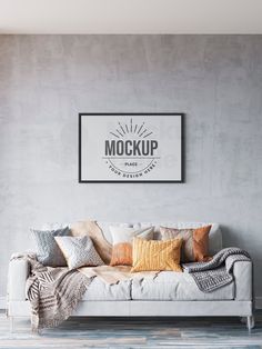 a living room with a couch, rug and poster on the wall that says mock up