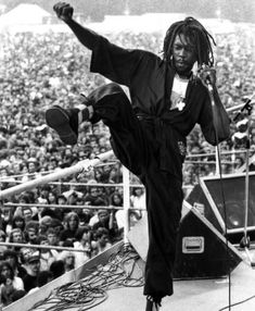 a man standing on top of a stage in front of a crowd