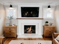 a living room filled with furniture and a flat screen tv mounted above a fire place