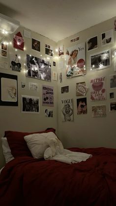 a bedroom with pictures on the wall and lights strung from the ceiling over the bed