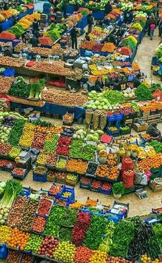 an outdoor market with lots of fruits and vegetables