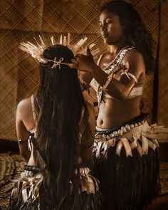 two women in native clothing standing next to each other