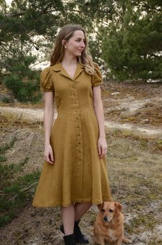 Introducing our beautiful linen midi dress - a timeless blend of classic charm and modern elegance. Crafted from 100% natural linen, this dress offers comfort and style for any occasion. With a charming collar and puffy sleeves, it adds a graceful touch to your look. It's perfect for warm days or outdoor gatherings. And the best part? Thoughtfully placed hidden pockets that seamlessly combine practicality and style. Note: Each dress is carefully handmade with attention to detail, ensuring the hi Classic Solid Color Midi Shirt Dress, Classic Solid Midi Shirt Dress, Classic Midi Dress With Covered Buttons For Daywear, Summer Dresses With Fitted Bodice And Buttons, Solid Color Fitted Knee-length Vintage Dress, Puff Sleeve Vintage Dress For Summer, Classic Summer Dresses With Button Closure, Daywear Short Sleeve Midi Dress With Fitted Bodice, Classic Midi Dress With Buttons For Daywear