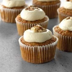 several cupcakes with frosting and nuts on top