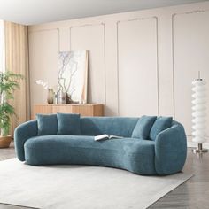 a blue couch sitting on top of a white rug