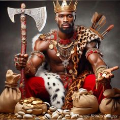 a man dressed as a warrior holding an ax and sitting on some rocks with other items around him