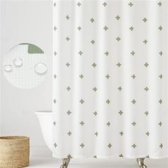 a white shower curtain with green crosses on it next to a bathtub and basket