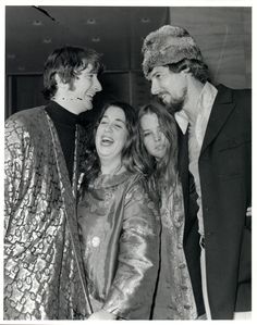 three people standing next to each other smiling