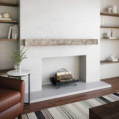 a living room with a fire place in the center and shelves on either side of the fireplace