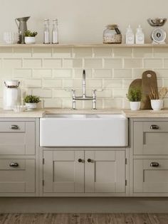 a white kitchen sink sitting under a window