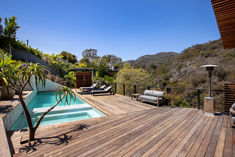 an outdoor deck with lounge chairs and a swimming pool