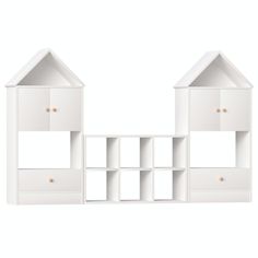 a white shelf with two small houses on it