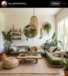 a living room filled with lots of furniture and plants on top of the wall next to a window