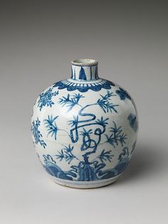 a blue and white vase sitting on top of a table