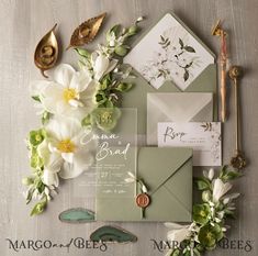 the wedding stationery is laid out with flowers