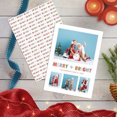 a christmas card with two photos on it next to some candles and decorations, including pine cones